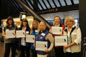 Travel agents at airport with signs