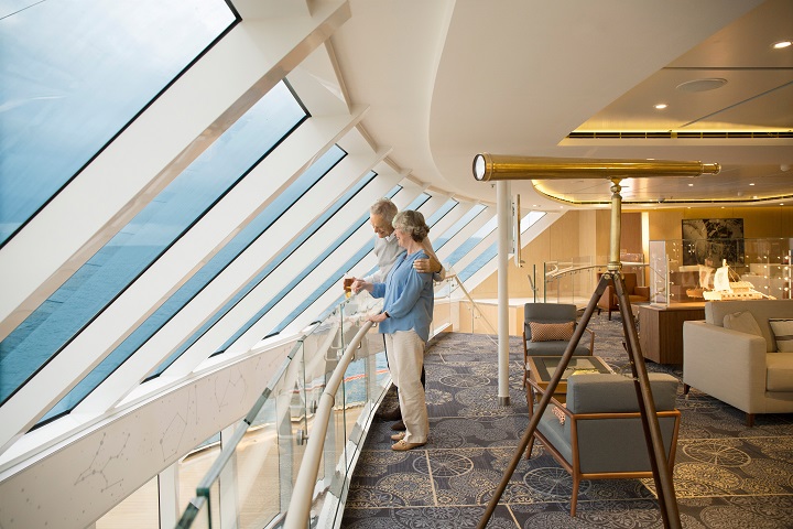 couple looking out window on cruise ship