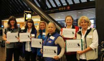 Travel agents at airport with signs