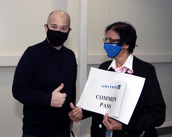 Traveler with mask and and airline personnel
