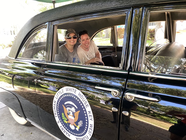 women in limo with presidential seal on it
